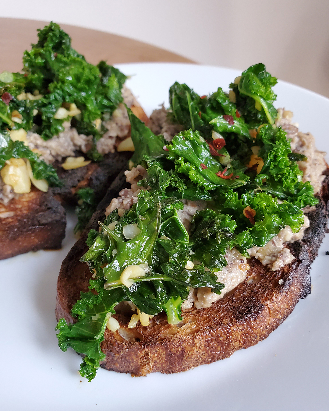 Pigeon Pea Hummus Toast Topped with Sautéed Garlic and Kale